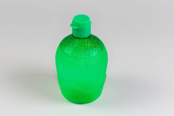 istock Lime juice concentrate in closed plastic container on gray background 2164932671