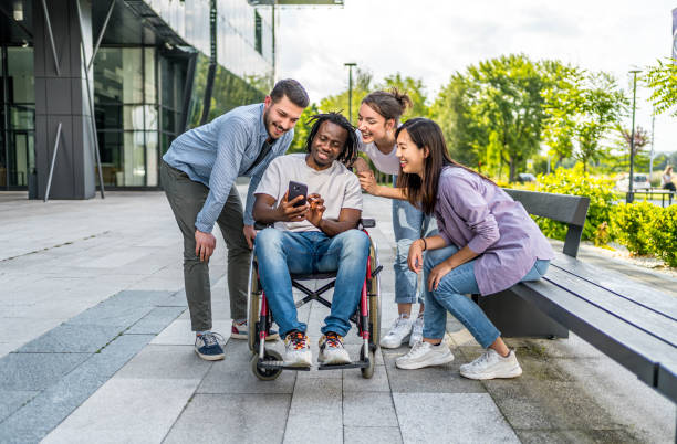 istock Cheerful friends using phone together outdoors 2164933567