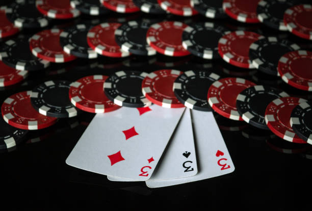 istock Three aces on the background of chips received from winning or successful combination of three kind or set. Concept of successful victory in poker club on black background 2164934473