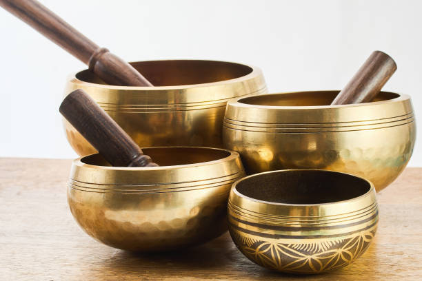 istock Golden Singing Bowls on a wooden surface 2164935090