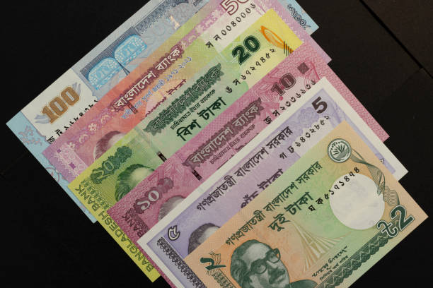 istock Bangladeshi taka currency notes isolated black background 2164935261