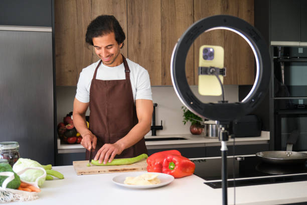 istock Indian food blogger recording cooking show using smartphone in kitchen 2164935514