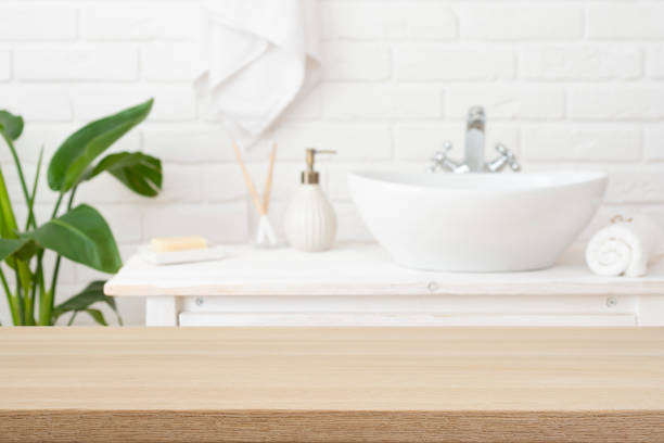 istock Empty wooden top table with blurred bathroom interior background for product display montage 2164936874
