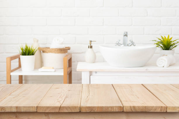 istock Table top from wooden planks for product display in blurred spa bathroom interior background 2164937106