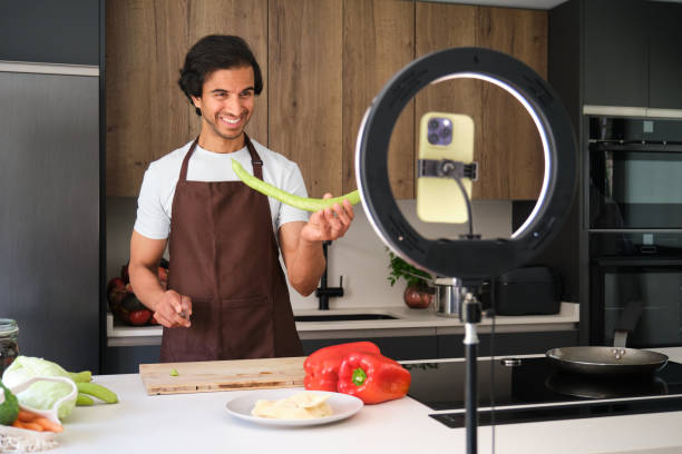 istock Indian food blogger showing vegetables while recording cooking tutorial 2164938820