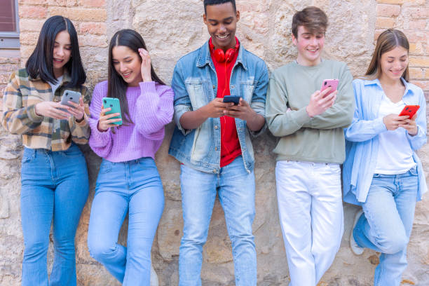 istock Five students having fun with mobile phones creating content on social media. 2164940261