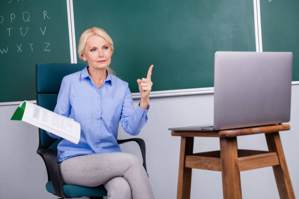 Photo of qualified confident woman school teacher tell information lesson explain materials college school Photo of qualified confident woman school teacher tell information lesson explain materials college school. qualified report stock pictures, royalty-free photos & images