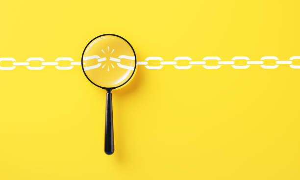 Black magnifier over a broken chain link on yellow background. Weakest link concept.