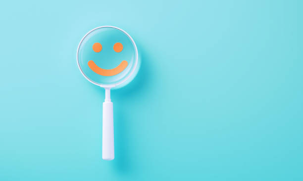 istock Colorful Magnifiers Over Orange Smiley Face On Blue Background 2164943653