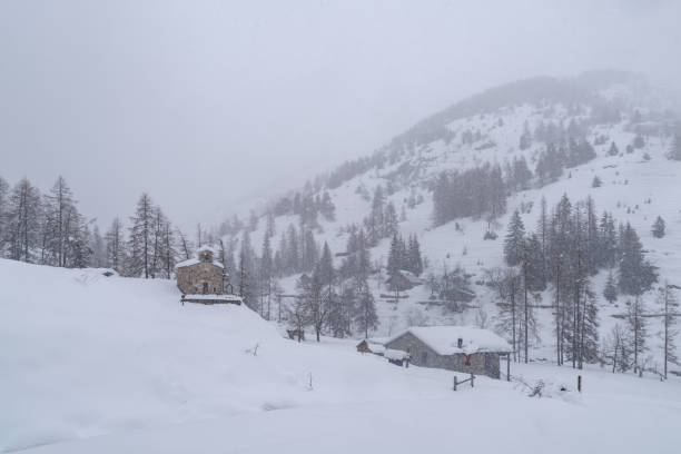 istock Small church in winter mountains 2164948585