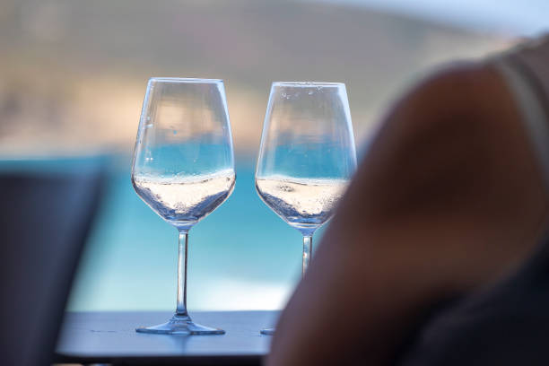 istock Wine glasses against a beautiful ocean backdrop. 2164950352