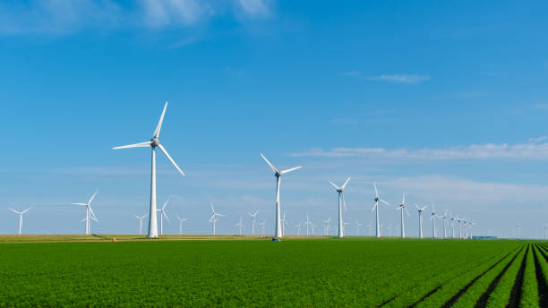istock Turbines Spinning Gracefully Amidst Lush Green Fields in the Netherlands 2164952445