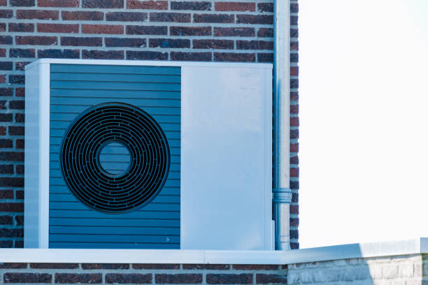 istock Efficient Air Source Heat Pump Installed on a Modern Brick Wall in Bright Daylight 2164952647