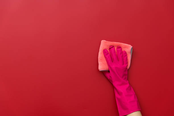 istock Woman hand cleaning red wall with rag 2164953360