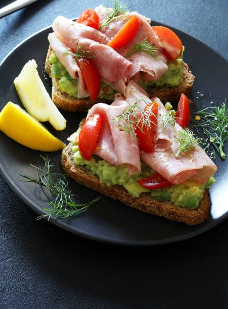 istock Avocado toast with prosciutto and tomato. 2164955113