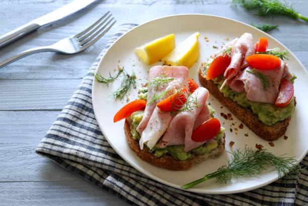 istock Avocado toast with prosciutto and tomato. 2164955119