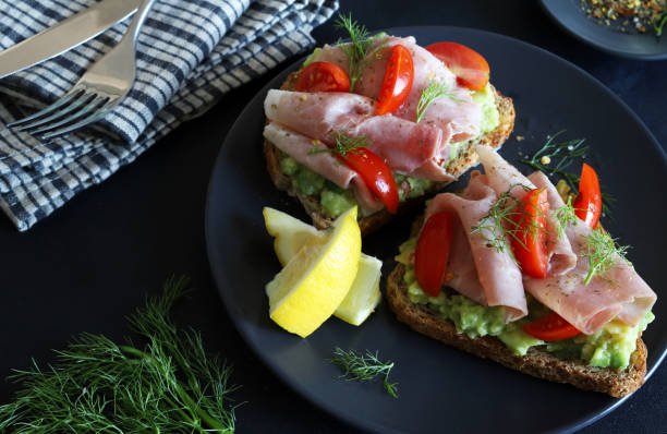 istock Avocado toast with prosciutto and tomato. 2164955121