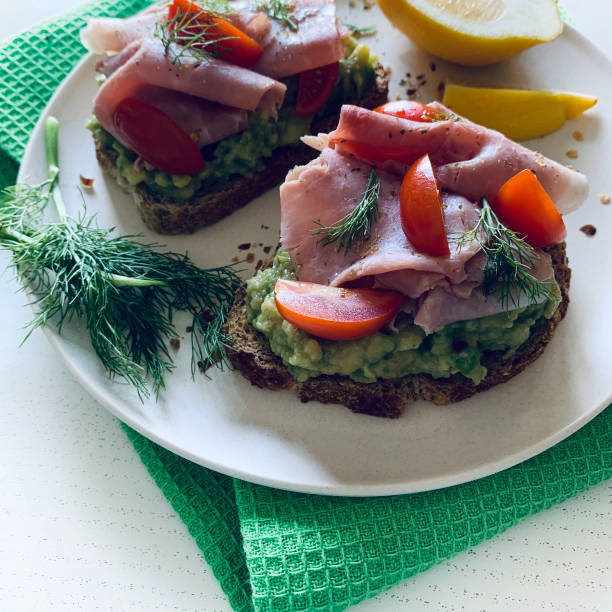 istock Avocado toast with prosciutto and tomato. 2164955148