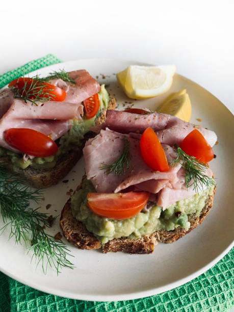 istock Avocado toast with prosciutto and tomato. 2164955188