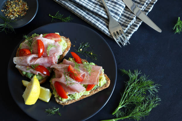 istock Avocado toast with prosciutto and tomato. 2164955193