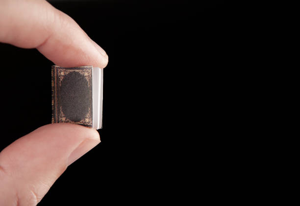 istock image of book hand dark background 2164959354
