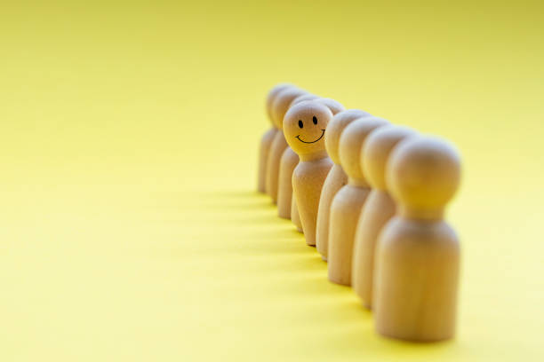 istock A wooden figure looking with happy face. Representing satisfaction or happy with something 2164963782