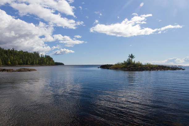 View of Lake Ladoga from Valaam Island. Bright summer day, the coast and a small island are visible, there are clouds in the sky