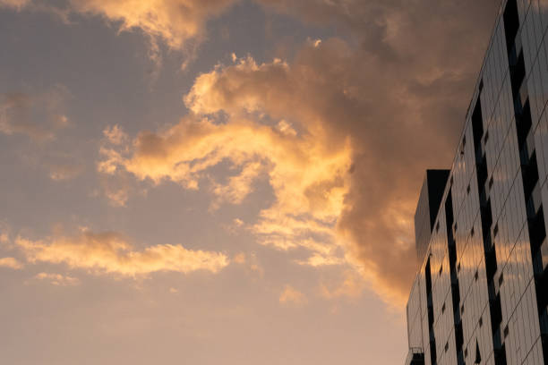 istock Sunset and dramatic clouds reflected in the windows of a skyscraper 2164967716