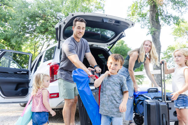 istock Children help mom and dad by carrying items for camping 2164968945