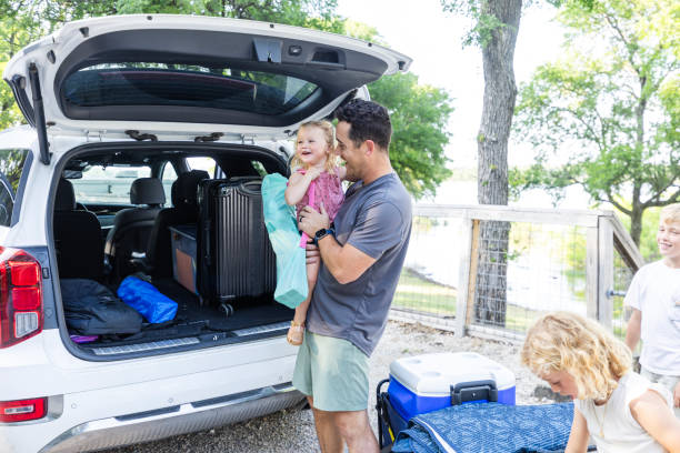 istock Dad takes break from unloading to hold toddler daughter 2164968995