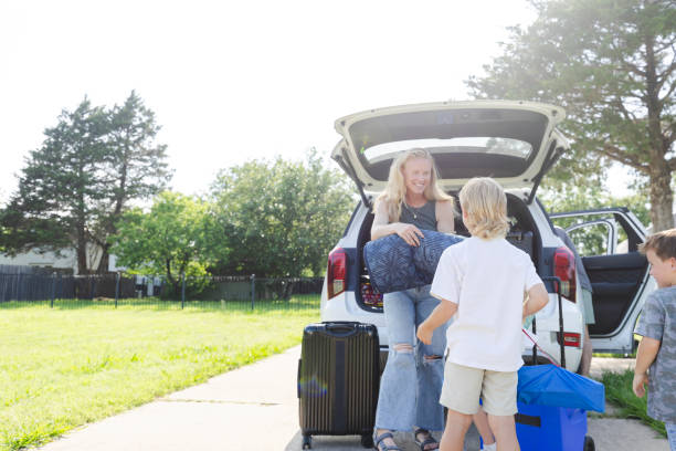 istock Sons help mom load car for vacation 2164969071