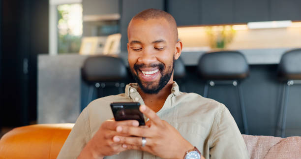 Laugh, cellphone and black man texting for communication, digital conversation and online chat. Tech, notification and mobile app for male person, smile and social media for comedy show streaming