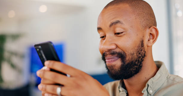 istock Reading, cellphone and black man scrolling for online, digital conversation and chat. Technology, notification and mobile app for male person, smile or social media for internet show streaming 2164969180