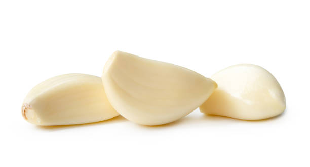 istock Side view of peeled white garlic clove in stack isolated on white background with clipping path 2164970563