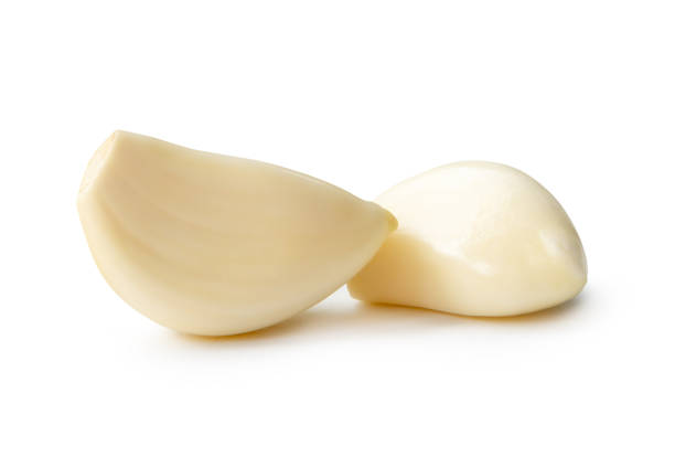 istock Side view of white garlic cloves in stack isolated on white background with clipping path 2164970564