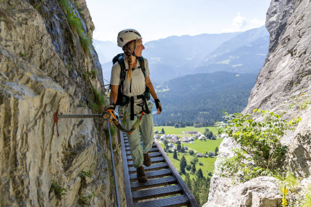 istock Climber on narrow elevated path with scenic mountain view 2164976869