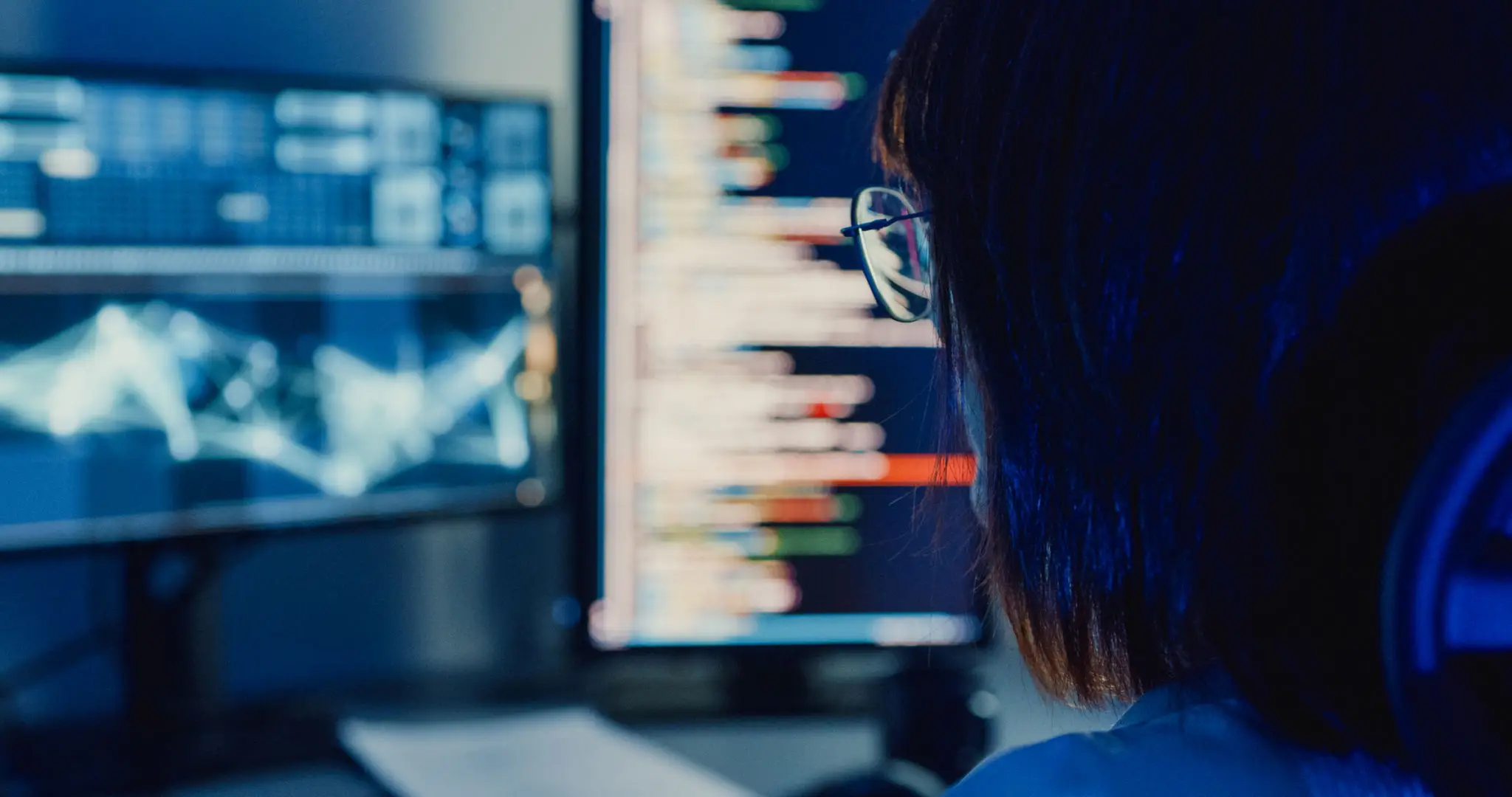 컴퓨터와 함께하는 파이썬 함수 최적화 2 Closeup Asian woman software developers using computer to write code application program for AI technology at desk with multiple screens work at home office night. Programmer development.
