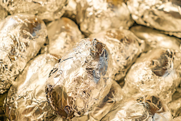 Potatoes in foil. Baking potatoes. Eating on coals. Picnic in the park.