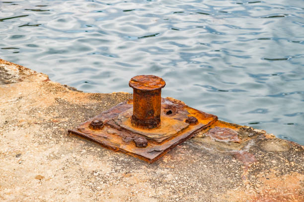 istock rusty old bollard on concrete pier, close-up 2164981982