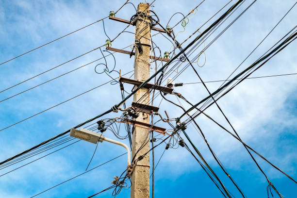 istock power line post with multiple wires, close-up against blue sky 2164982095