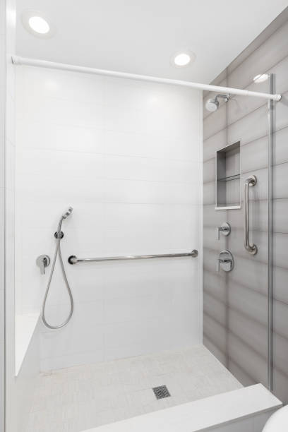 istock A walk-in shower with white and brown tiles. 2164989676