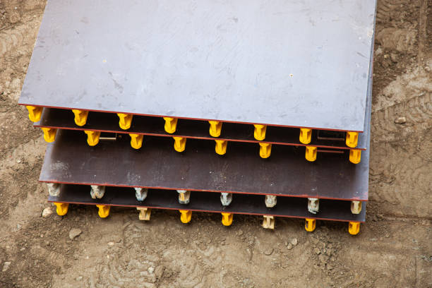 Two phenolic plywood boards used as formwork in a renovation project, showcasing construction site materials and progress.