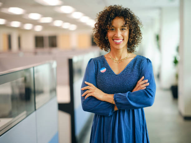 istock Woman With I VOTED Sticker 2164994804
