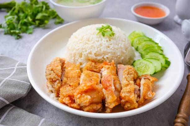 istock Fried Chicken and rice, rice, chicken, hainanese fried chicken rice, crispy fried chicken ,coriander, cucumber, asian food, thai cuisine, khao man gai tod 2164996348
