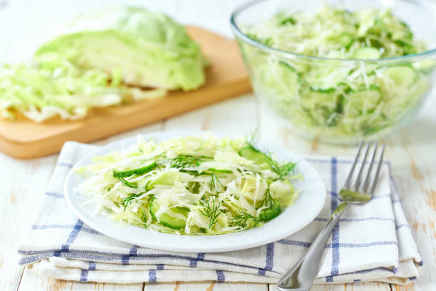 istock crispy organic green cabbage salad in a plate, selective focus. 2164998160