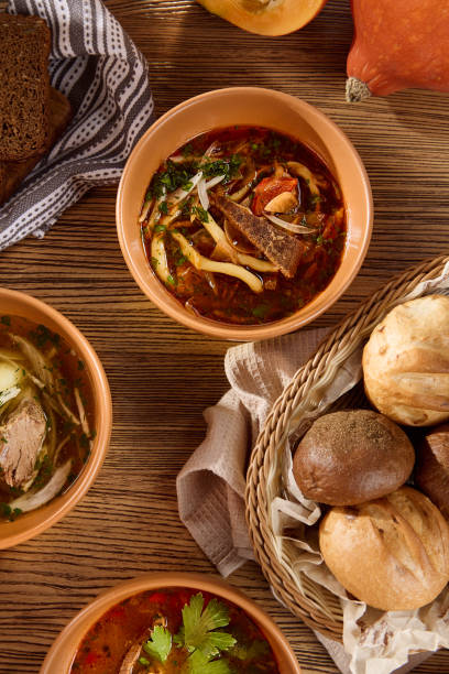 istock Delicious Beef Lagman Soup with Fresh Vegetables and Bread in Rustic Setting 2164998546