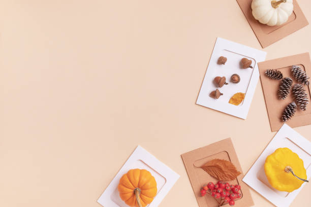 istock Autumn or fall concept. Pumpkins, berries, acorns and cones on beige table top view. 2165003270