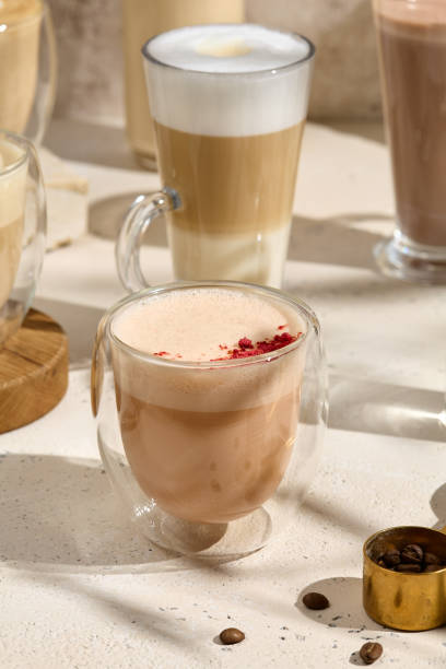 istock Raspberry Raff Coffee in a Glass Cup with Latte Art and Coffee Beans on a Light Table 2165006492