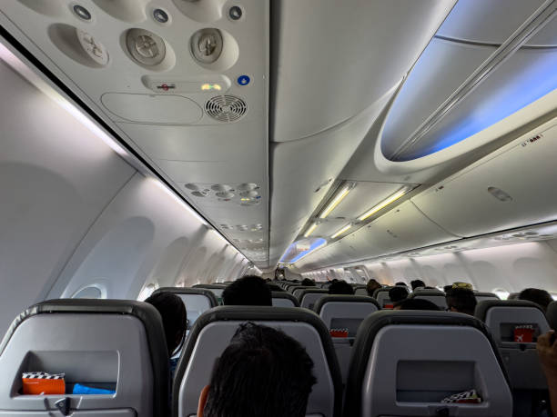 istock Interior of an modern airplane cabin with seated passengers. preparing for takeoff 2165011137