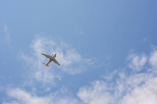 istock A passenger plane flies high in the blue sky with light clouds. 2165012027